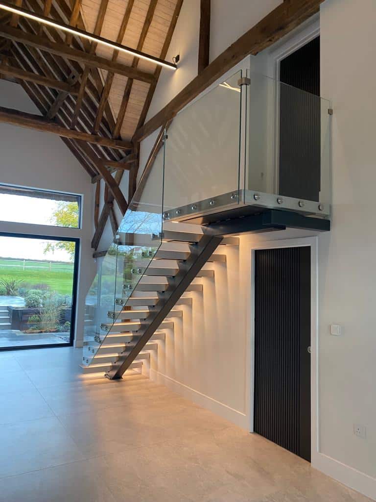 staircase with wood, glass, and steel