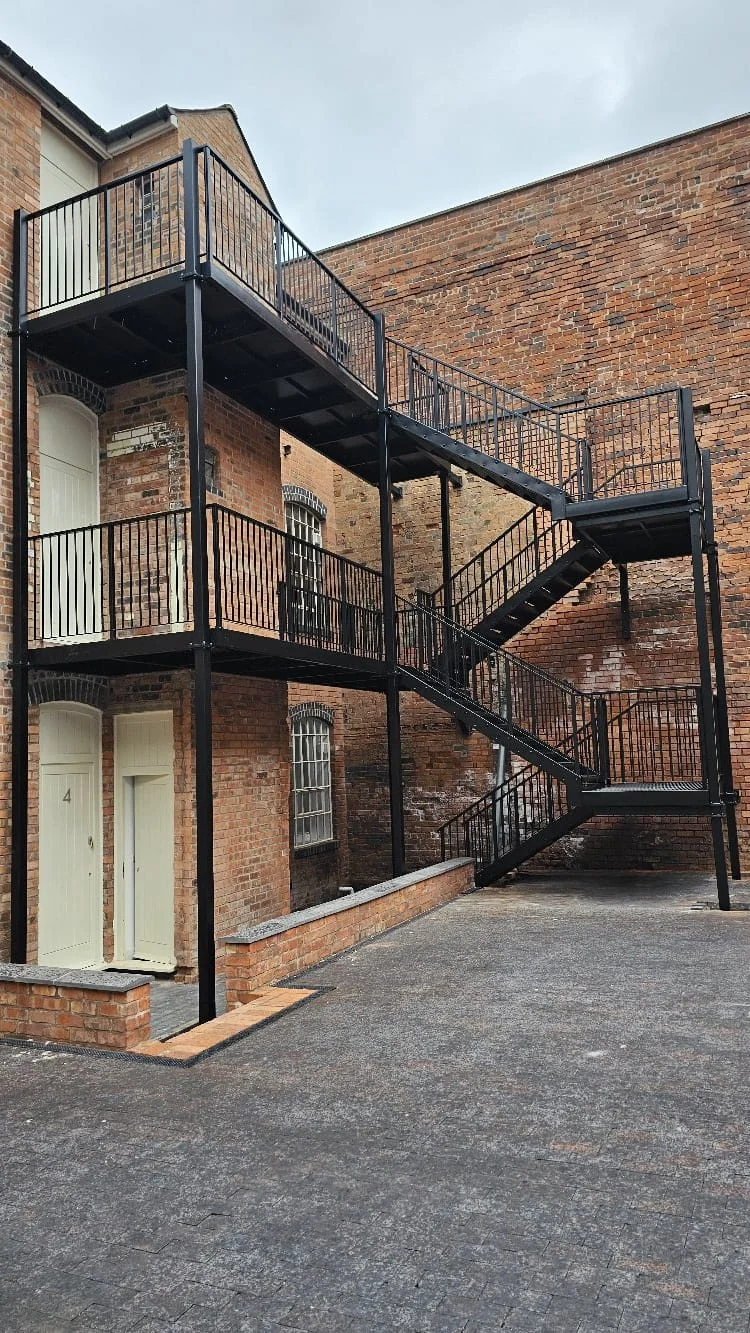 Black powder-coated multi-storey fire escape staircase